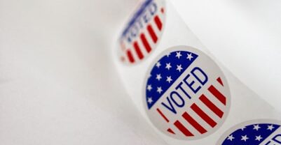 a close up of a toothbrush with the word vote written on it